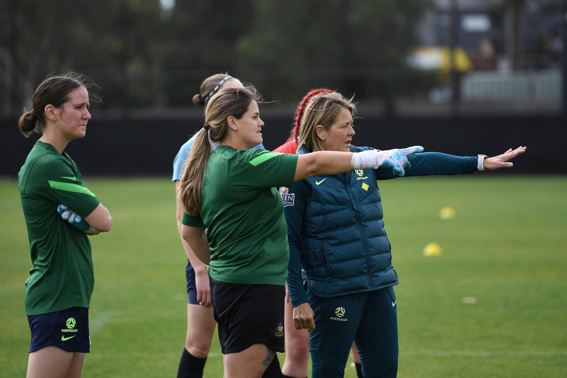 ParaMatildas training. Katelyn Smith (goalkeeper) and a coach are pointing out something in the distance. Carly Salmon (goalkeeper) is standing arms crossed on the left.