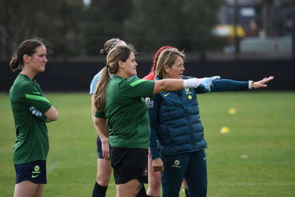 ParaMatildas training. Katelyn Smith (goalkeeper) and a coach are pointing out something in the distance. Carly Salmon (goalkeeper) is standing arms crossed on the left.